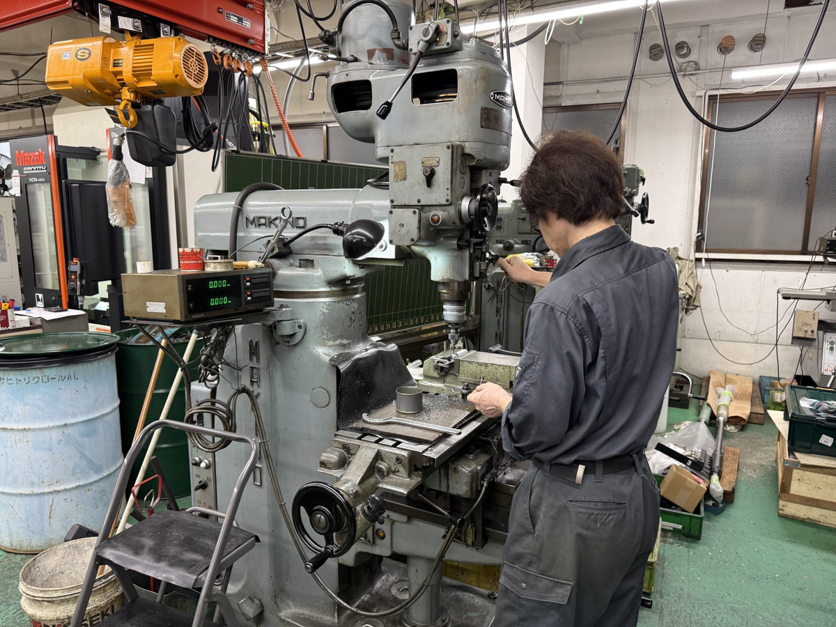Tosho Seiko factory — a machinist at work